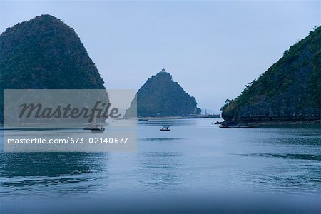 Bateaux et îles au crépuscule sur la baie de vietnamienne