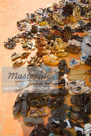 Shoes on bricks outside Vietnamese temple