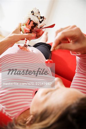 Pregnant woman eating ice cream sundae