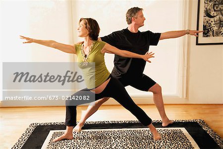 Pregnant couple practicing yoga