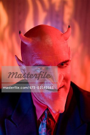 Close up of businessman dressed as devil