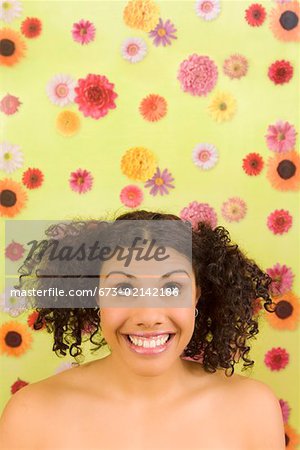 Woman looking up in front of flower background