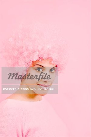 Portrait of woman wearing pink wig