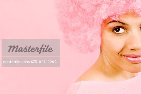 Close up of woman wearing pink wig