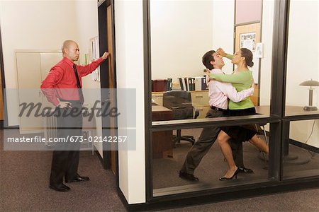 Businesspeople dancing in office