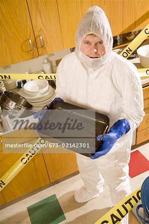 Man wearing coveralls to clean dirty kitchen