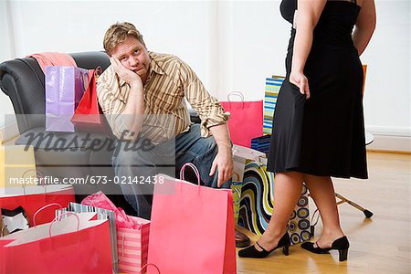 Woman trying on new clothes for bored husband