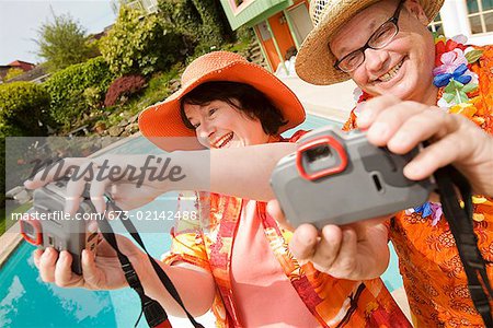 Couple wearing festive outfits taking self portraits