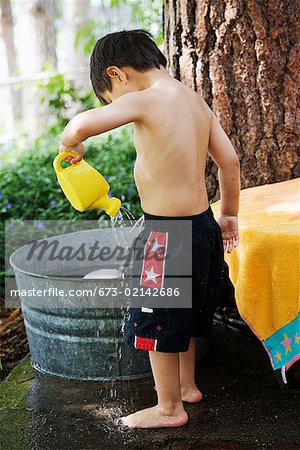 Young boy playing with water