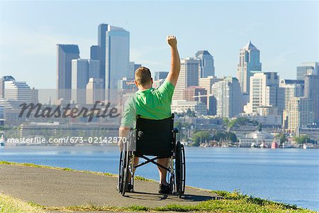 Man in wheelchair looking at city skyline