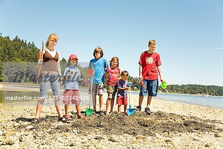 Group of children digging at beach