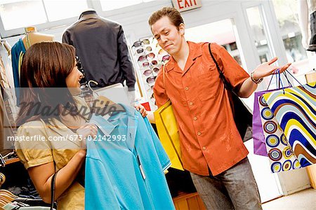 Hispanic couple shopping in clothing store