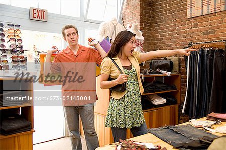 Hispanic couple shopping in clothing store