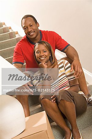 African couple sitting on stairs