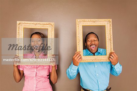 African couple looking through picture frames