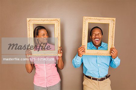 African couple looking through picture frames