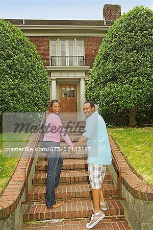 African couple walking towards house