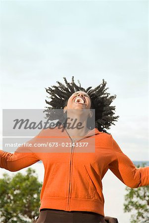 African woman laughing with head back