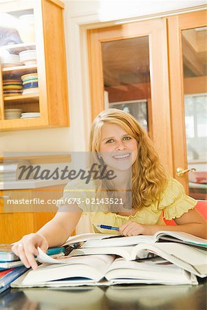 Teenage girl studying at table
