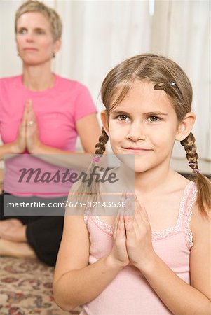 Mother and daughter practicing yoga