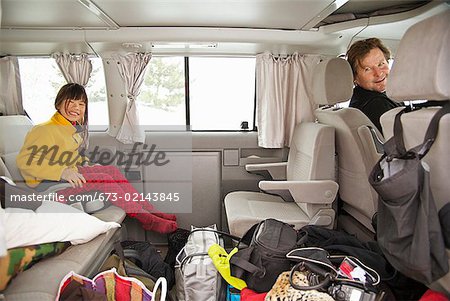 Father and daughter in car with luggage