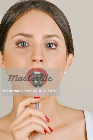 Female young adult eating a lollipop