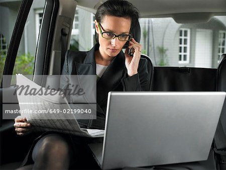 Woman in car, working