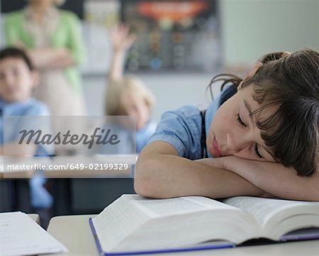 School girl sleeping at desk