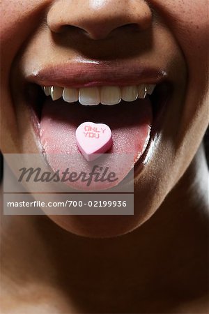 Woman with Valentine Candy on Tongue