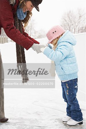 Mother Teaching Daughter to Skate