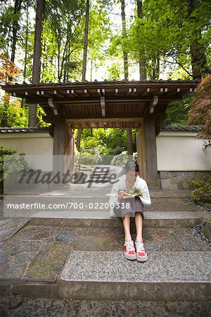 Woman Reading Book at Entrance to Japanese Garden, Washington Park, Portland, Oregon, USA