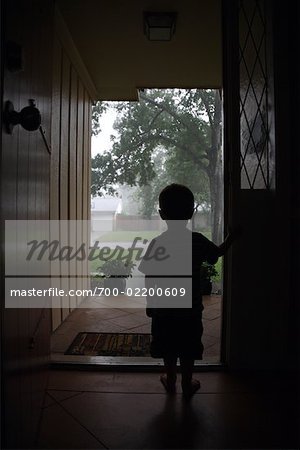 Boy Looking Out of Doorway, Conroe, Texas, USA