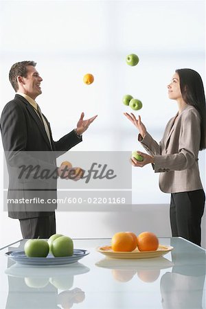 Business People Juggling Apples and Oranges