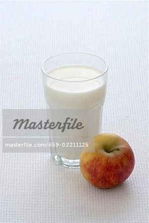 A glass of milk and an apple