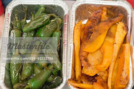Grilled vegetables in aluminium containers (overhead view)