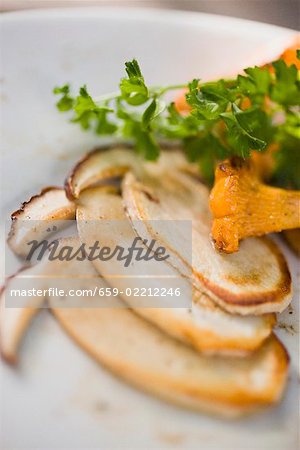 Fried cep slices and chanterelle with parsley