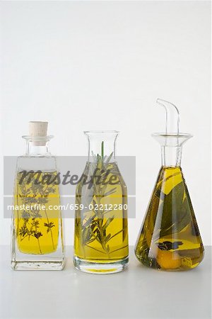 Three different herb oils in bottles standing in a row