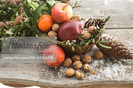 Rustic Christmas decoration with apples, nuts and cones