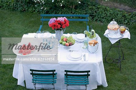 Table laid in garden for a summer party