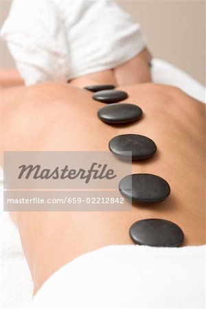 Woman having LaStone Therapy (healing therapy using stones)