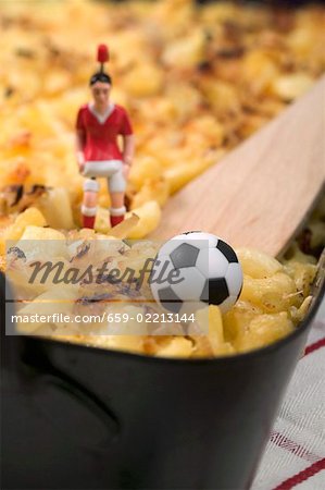 Cheese & onion pasta bake, football figure & football (detail)