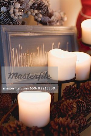 Candles, pine cones and festive sign