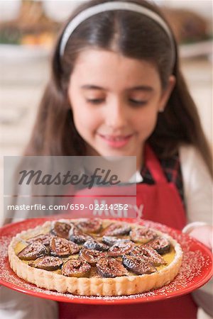 Girl holding freshly-baked fig tart