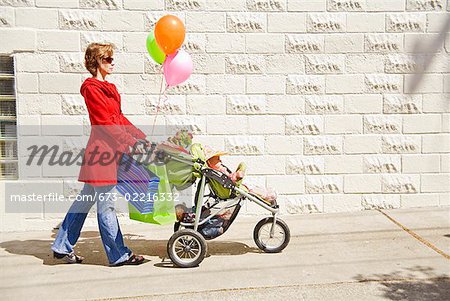 Woman pushing baby girl in stroller