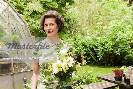 Woman holding flowers in garden