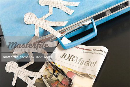 Paper dolls, briefcase and employment section of newspaper