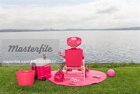 Woman in pink picnicking by bay