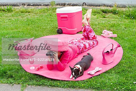 Woman in pink and dog picnicking