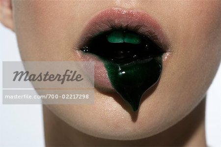 Close-up of Woman With Green Liquid Oozing From Mouth