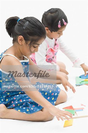 Two girls playing with puzzles